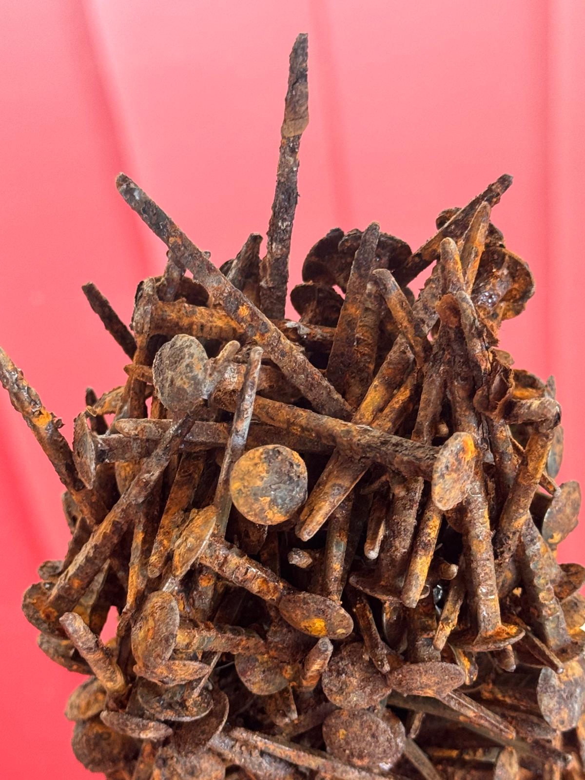 Close detail of the bound rusted nails.